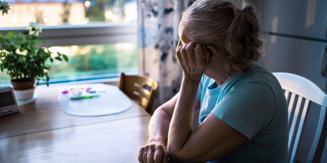 Sad old woman. Depressed lonely senior lady with alzheimer, dementia, memory loss or loneliness. Elder person looking out the home window.