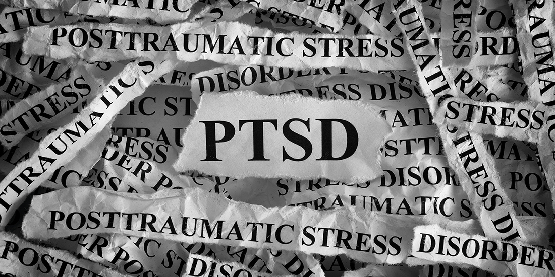 Torn pieces of paper with abbreviate PTSD. Posttraumatic stress disorder. Concept Image. Closeup.