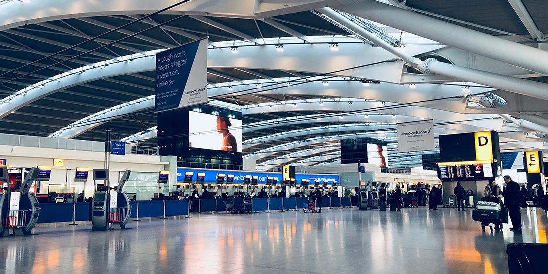 Airport check-in area with kiosks and a dome ceiling