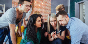 young people looking at phone