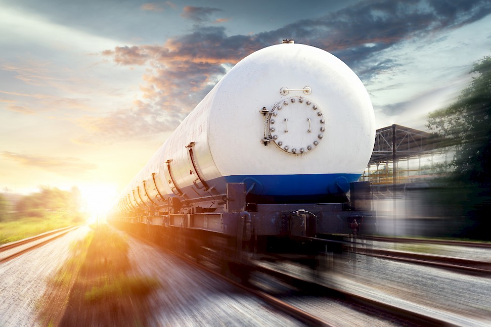 Tanks with gas being transported by rail at sunset