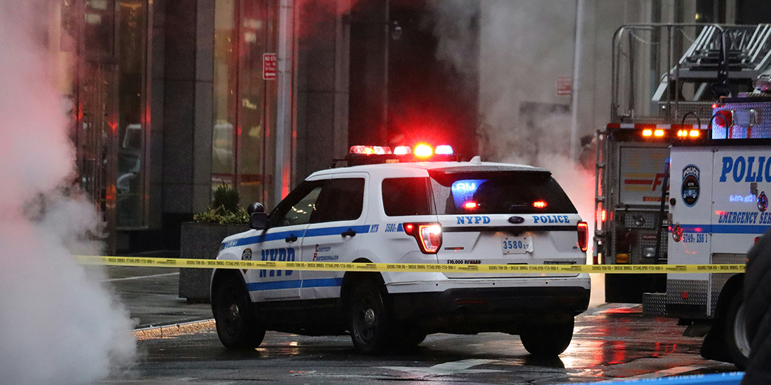 NYPD police car and other emergency vehicles behind police tape and surrounded with smoke