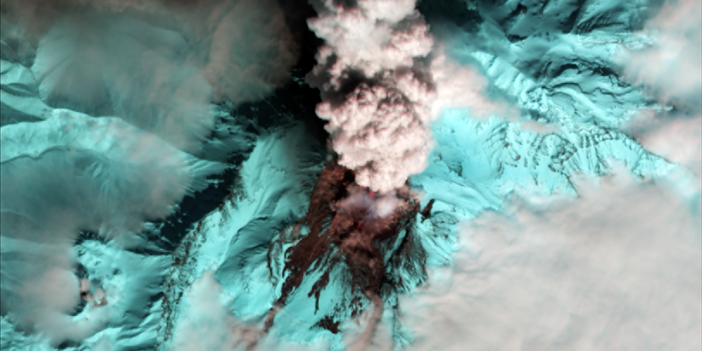 top view of live volcano in blue with smoke coming up