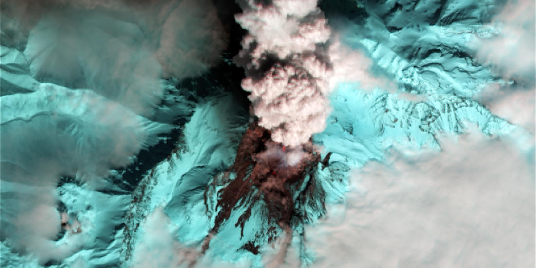 top view of live volcano in blue with smoke coming up
