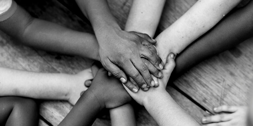 eight hands stacked on top of each other in a circle