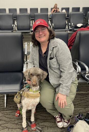 service dog and handler sitting in an airport