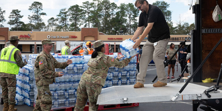 U.S. Army Soldiers with the Augusta-based 878th Engineer Battalion, 648th Maneuver Enhancement Brigade, Georgia Army National Guard, partner with Georgia State Defense Force personnel to unload cases of water during a point of distribution (POD) mission in Augusta, Georgia, Sept. 30, 2024. The Georgia National Guard has mobilized to provide response and recovery support to areas in the state impacted by Hurricane Helene. At the direction of the Governor and through The Georgia Emergency Management and Homeland Security Agency (GEMA/HS), the Georgia National Guard will continue to partner local, state, and federal entities in this effort. (U.S. Army National Guard photo by Spc. Ayanna Tillman)