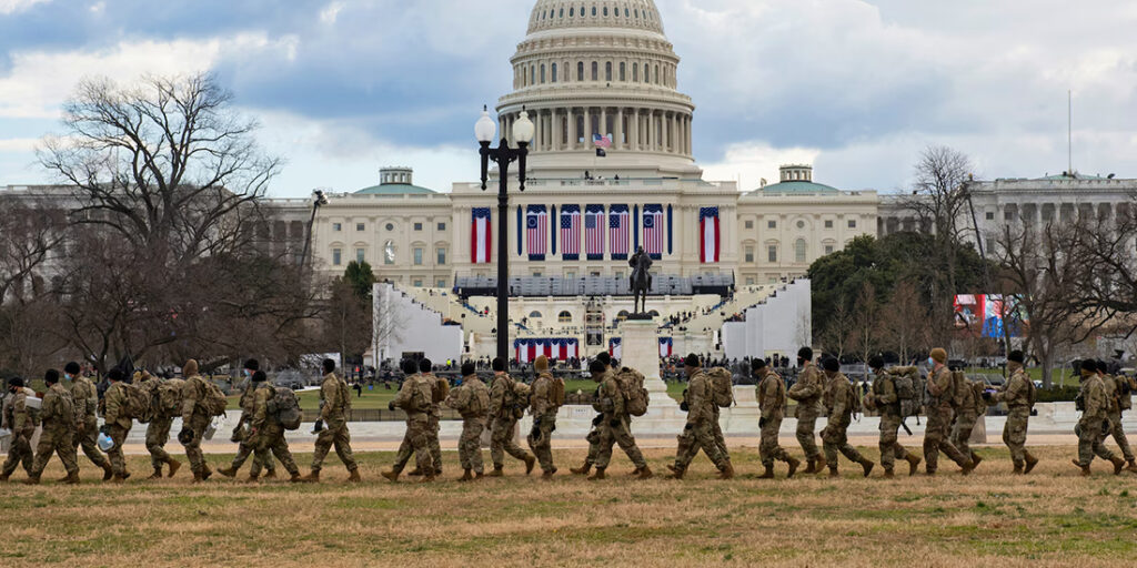 National Guardsmen walking in front of the U.S. Capitol