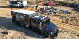 United Cajun Navy mobile command center at disaster site by trailer and debris