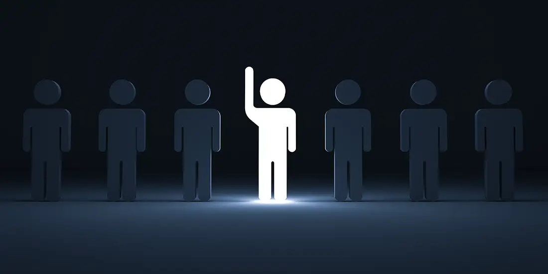 Illustration of seven human-shaped figures standing in a row against a dark blue background. One figure in the center is brightly illuminated in white and raising a hand, while the six surrounding figures are darker blue and less prominent.