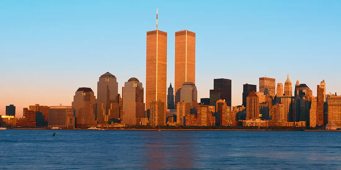 Panoramic view of lower Manhattan and Hudson River, New York City skyline, NY with World Trade Towers at sunset.