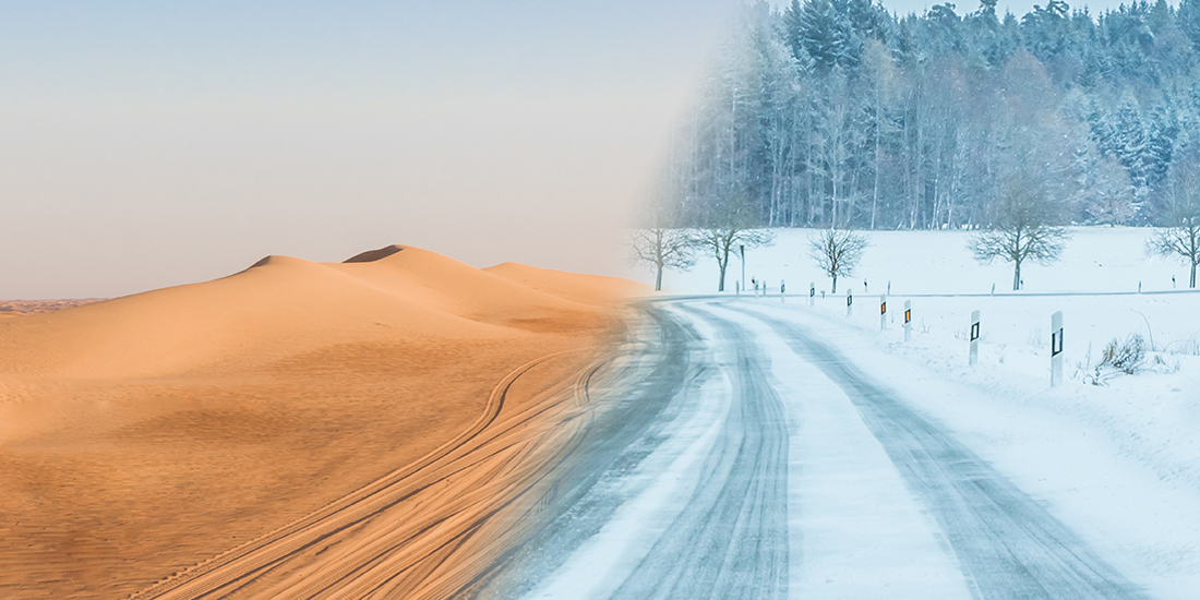 Split-scene image showing two contrasting climate environments connected by a roadway. On the left, golden sand dunes stretch across a desert landscape with tire tracks running through the sand under a pale sky. On the right, a snow-covered road curves through a winter landscape bordered by bare trees and a forest dusted with snow.